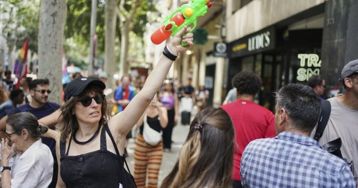 Spanish locals shoot water at visitors in protests against mass tourism – National | Globalnews.ca